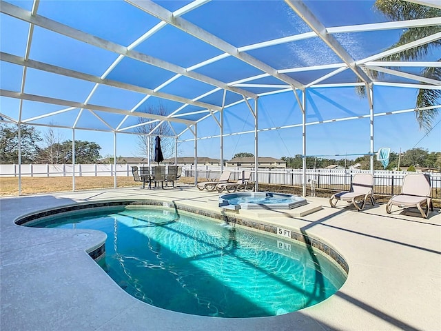 view of swimming pool with an in ground hot tub, a lanai, and a patio