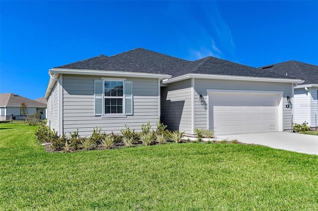 view of front of home featuring a garage and a front lawn