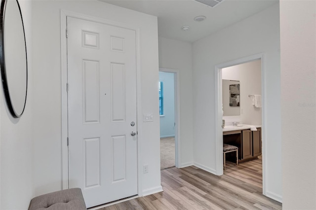 corridor with light hardwood / wood-style floors