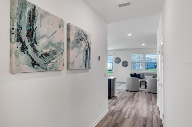 corridor with light hardwood / wood-style flooring