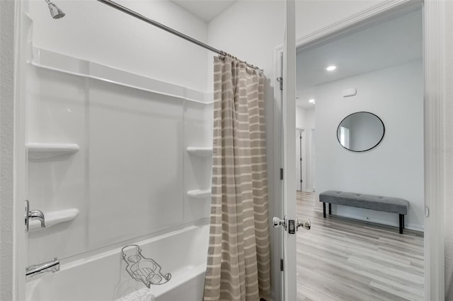 bathroom with wood-type flooring and shower / tub combo