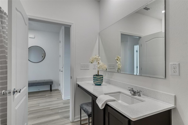 bathroom featuring vanity and hardwood / wood-style flooring