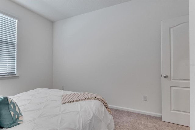 bedroom with light colored carpet