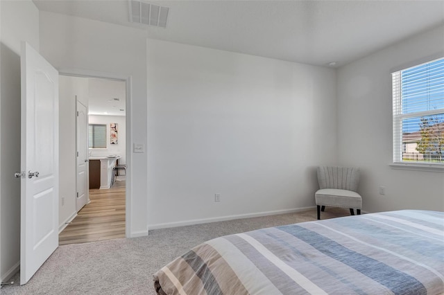 bedroom featuring light carpet