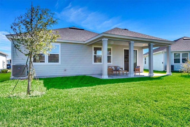 rear view of property featuring a patio, a yard, and central AC unit