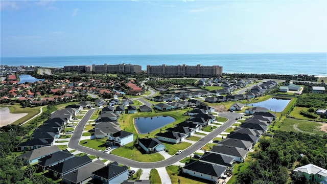 birds eye view of property featuring a water view and a residential view