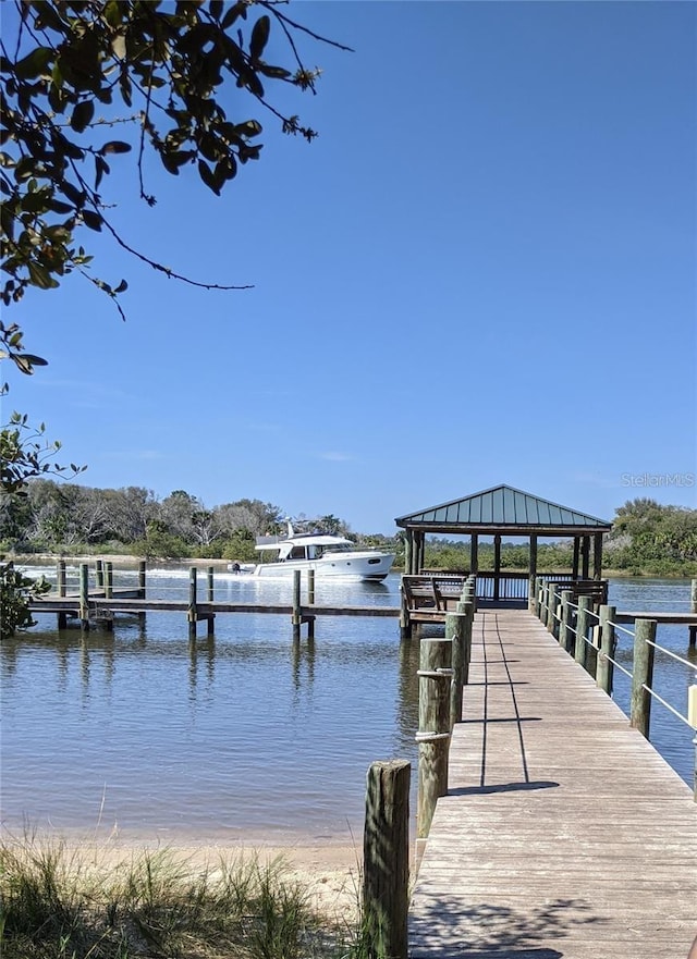 view of dock featuring a water view and a gazebo