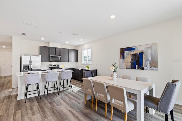 dining area featuring light wood-type flooring, visible vents, and recessed lighting