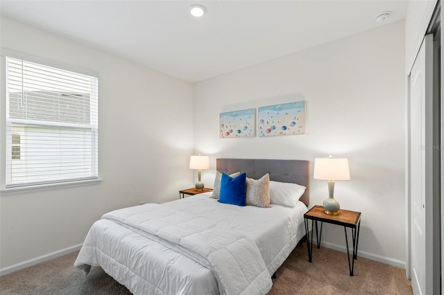 carpeted bedroom with baseboards