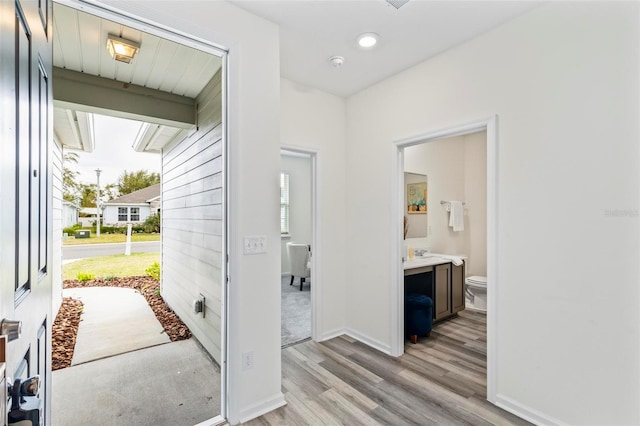 interior space featuring light wood-style flooring and baseboards