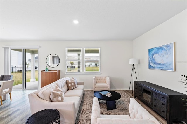 living area featuring light wood-style flooring and baseboards