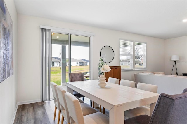 dining area with baseboards and wood finished floors