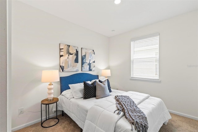 carpeted bedroom featuring baseboards