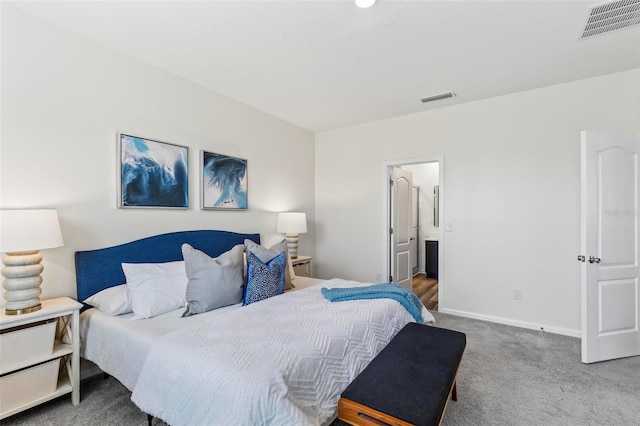 bedroom with carpet, visible vents, connected bathroom, and baseboards