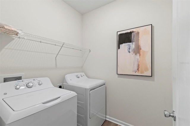 laundry room with baseboards, laundry area, and washer and dryer