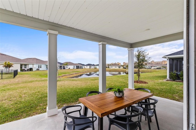 view of patio / terrace with a water view and a residential view