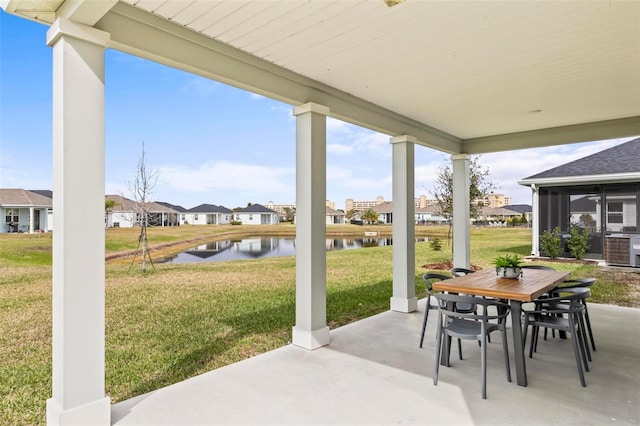 view of patio featuring a water view, a residential view, and outdoor dining area