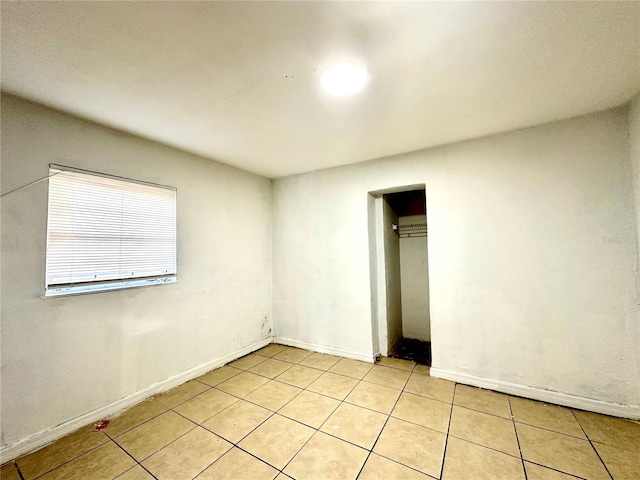 unfurnished bedroom with light tile patterned floors and a closet