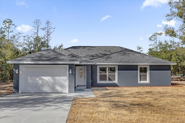 ranch-style house with a garage and a front yard