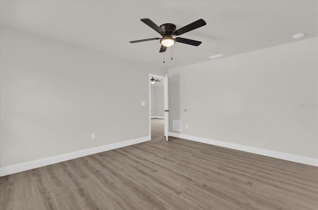 spare room with light hardwood / wood-style flooring and ceiling fan