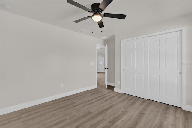 unfurnished bedroom with a closet, ceiling fan, and light wood-type flooring