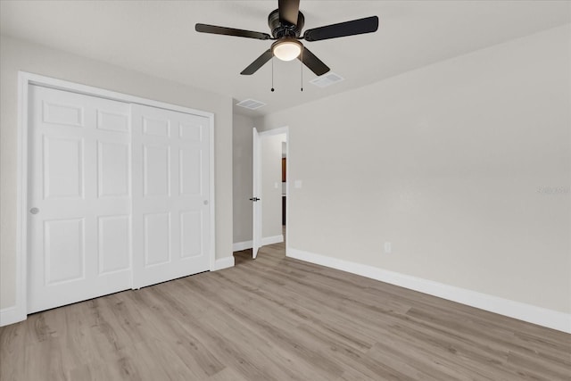 unfurnished bedroom featuring light hardwood / wood-style flooring, a closet, and ceiling fan