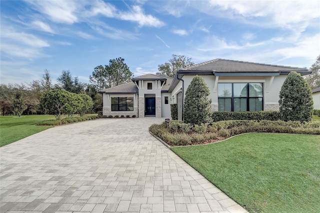 view of front of house with a garage and a front yard