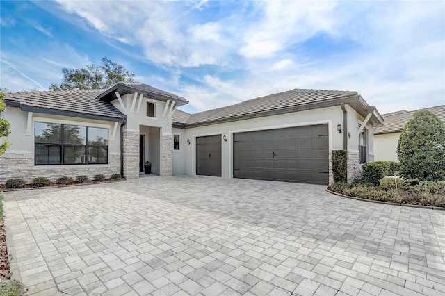 25974 High Hampton Cir, Sorrento, FL 32776 - view of front facade with stucco siding, an attached garage, stone siding, decorative driveway, and a tile roof