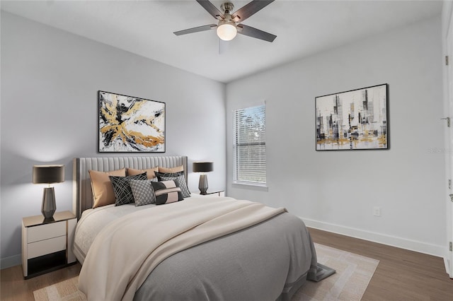 bedroom with ceiling fan and hardwood / wood-style floors