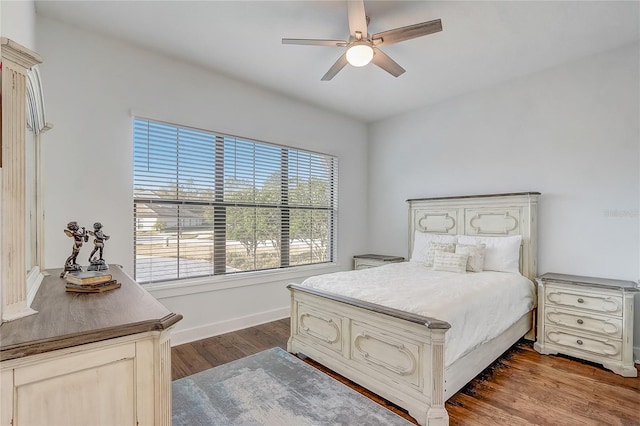 bedroom with dark wood-type flooring and ceiling fan