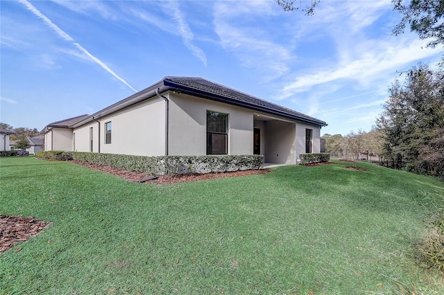 view of side of property with a lawn