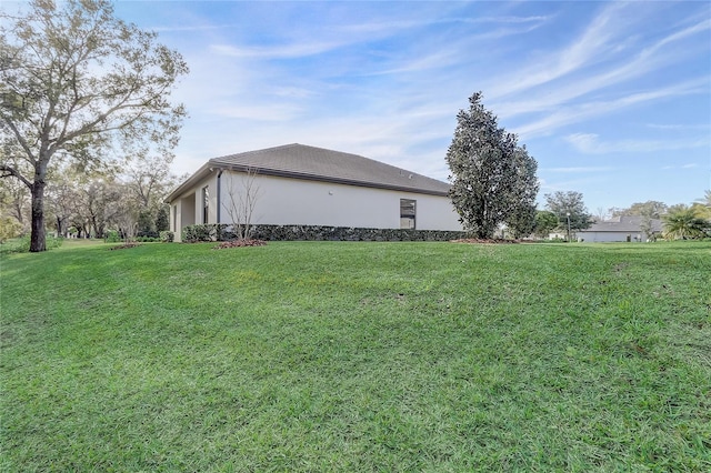 view of side of home featuring a lawn