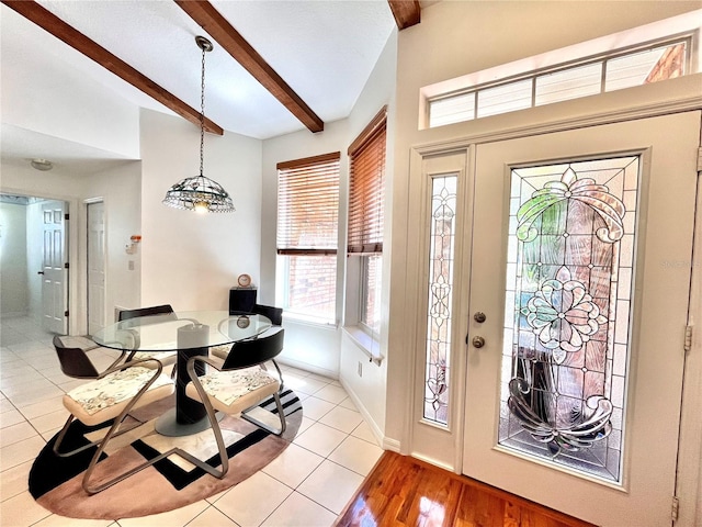 tiled foyer entrance with vaulted ceiling with beams