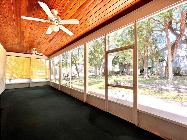 unfurnished sunroom with ceiling fan and wooden ceiling