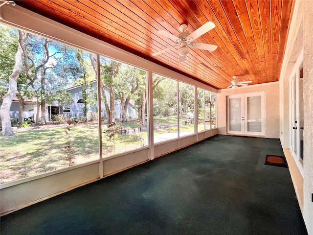 unfurnished sunroom featuring wooden ceiling and ceiling fan