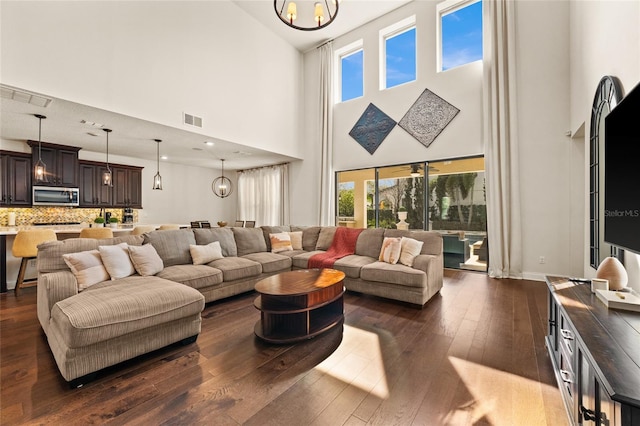 living room featuring dark hardwood / wood-style floors and a chandelier