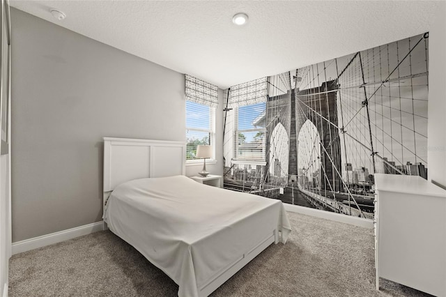 carpeted bedroom featuring a textured ceiling