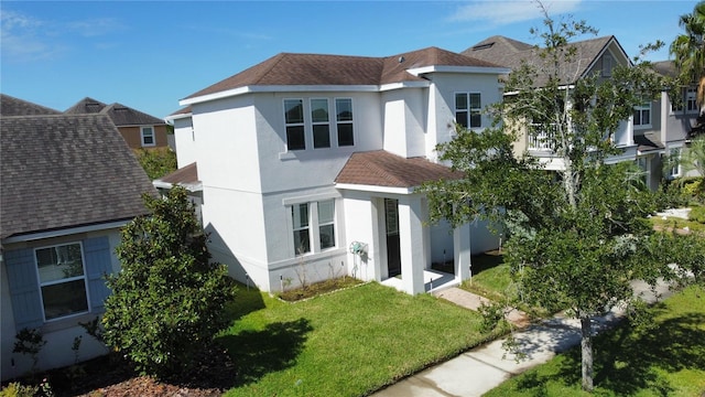 rear view of property with a lawn