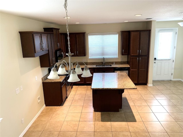 kitchen with sink, decorative light fixtures, a center island, and light tile patterned flooring