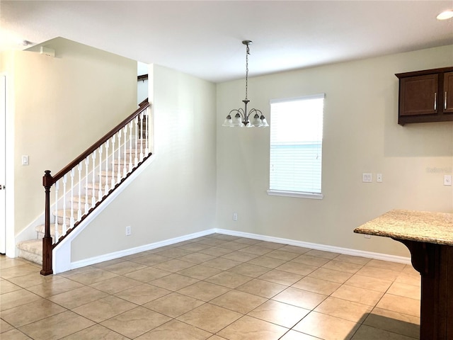 unfurnished dining area with light tile patterned floors and a chandelier