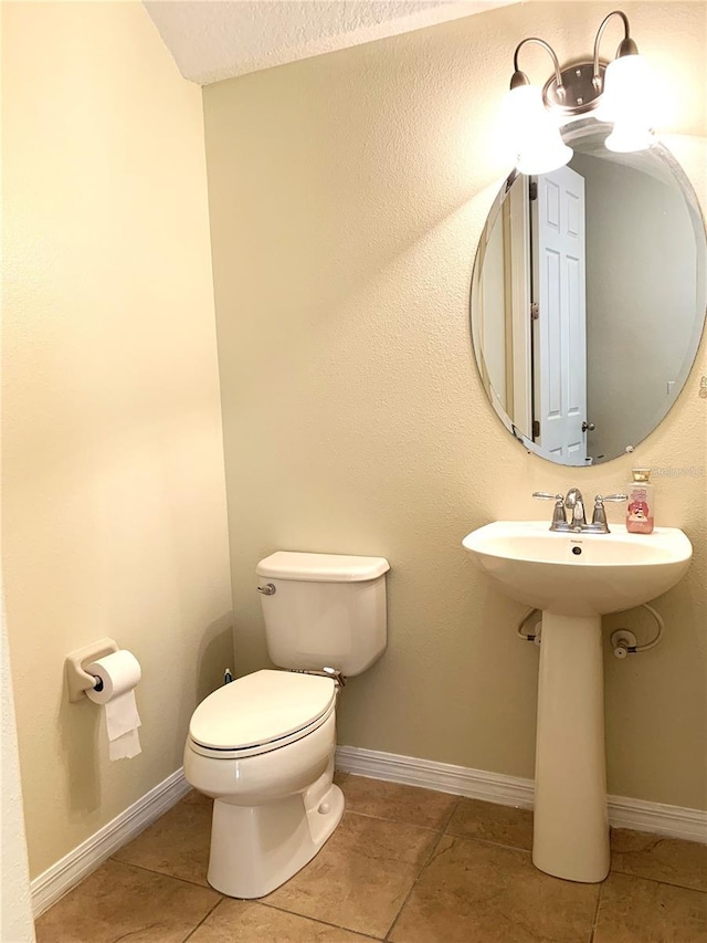 bathroom featuring tile patterned flooring, sink, and toilet