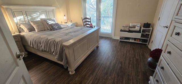 bedroom with dark hardwood / wood-style floors and access to exterior