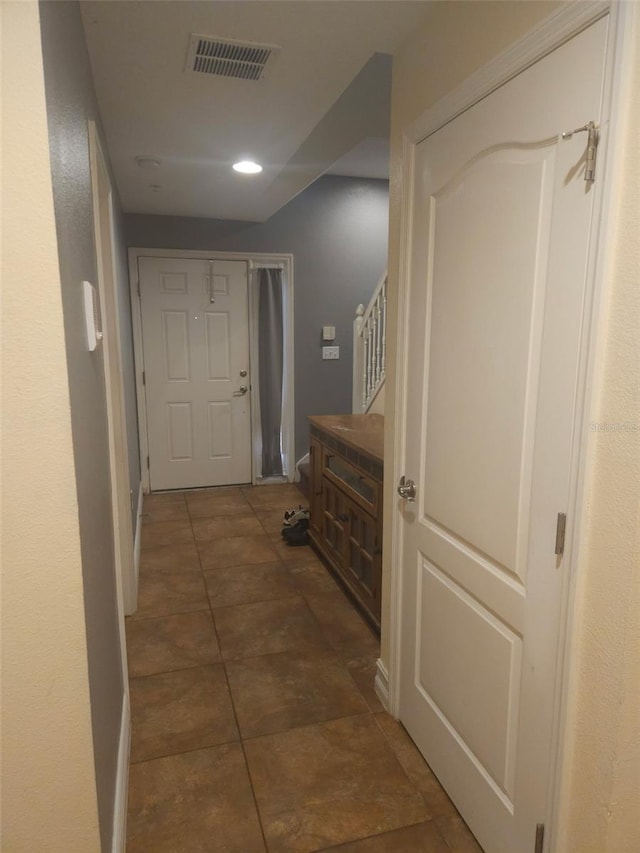 corridor with dark tile patterned flooring