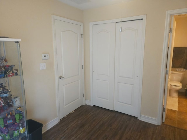 bedroom featuring dark hardwood / wood-style floors and a closet