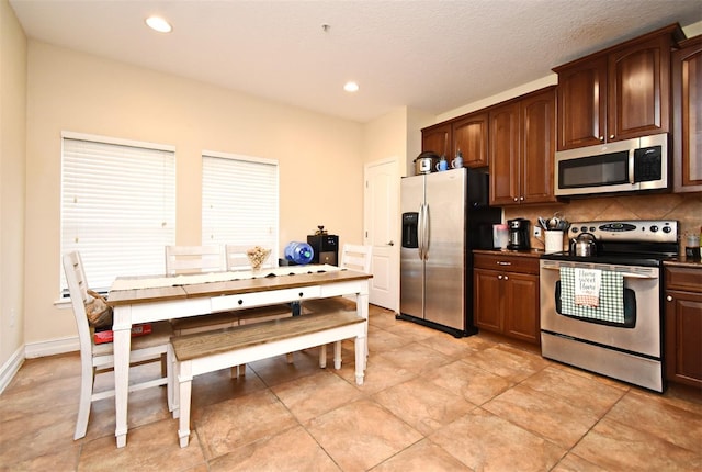 kitchen featuring stainless steel appliances and tasteful backsplash