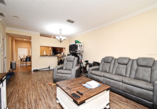 living room featuring a notable chandelier, crown molding, and hardwood / wood-style floors