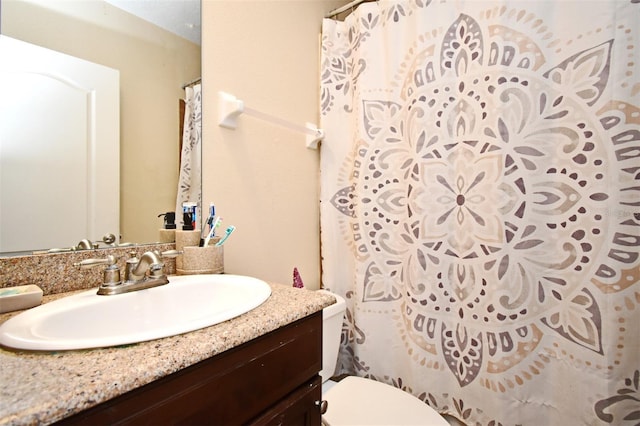 bathroom featuring vanity and toilet