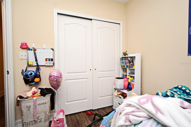 bedroom featuring dark hardwood / wood-style flooring and a closet