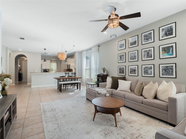 living room with light tile patterned floors and ceiling fan