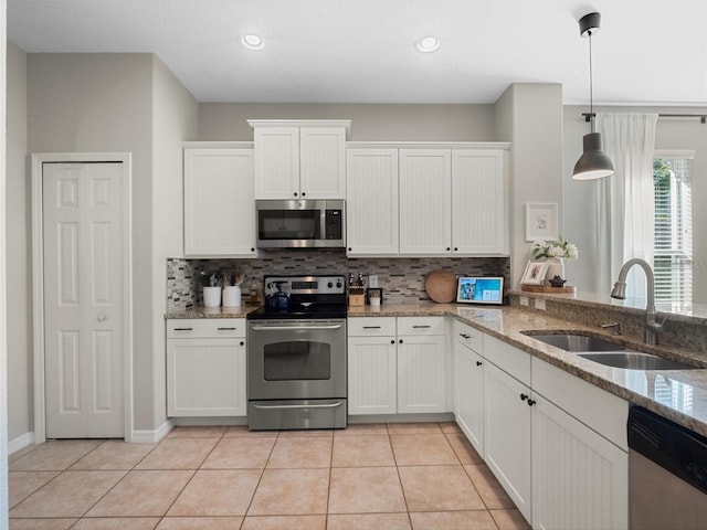 kitchen featuring sink, stainless steel appliances, and white cabinets